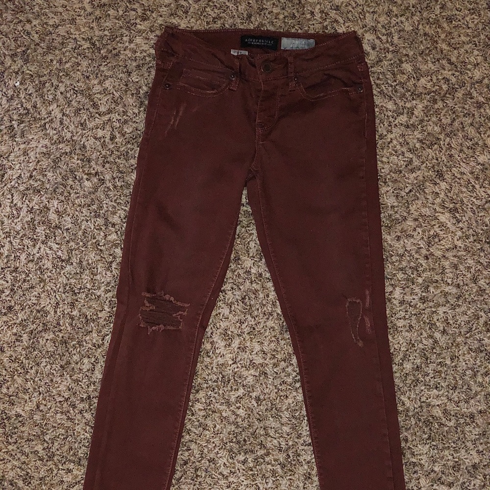 Burgundy ripped jeans